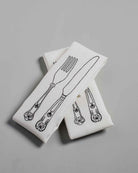 White Irish linen napkin with black knife and fork embroidery