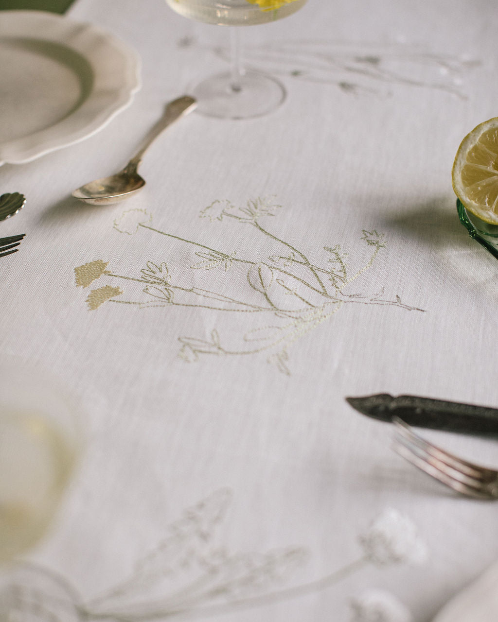 Plant embroidery on a white Irish linen table runner