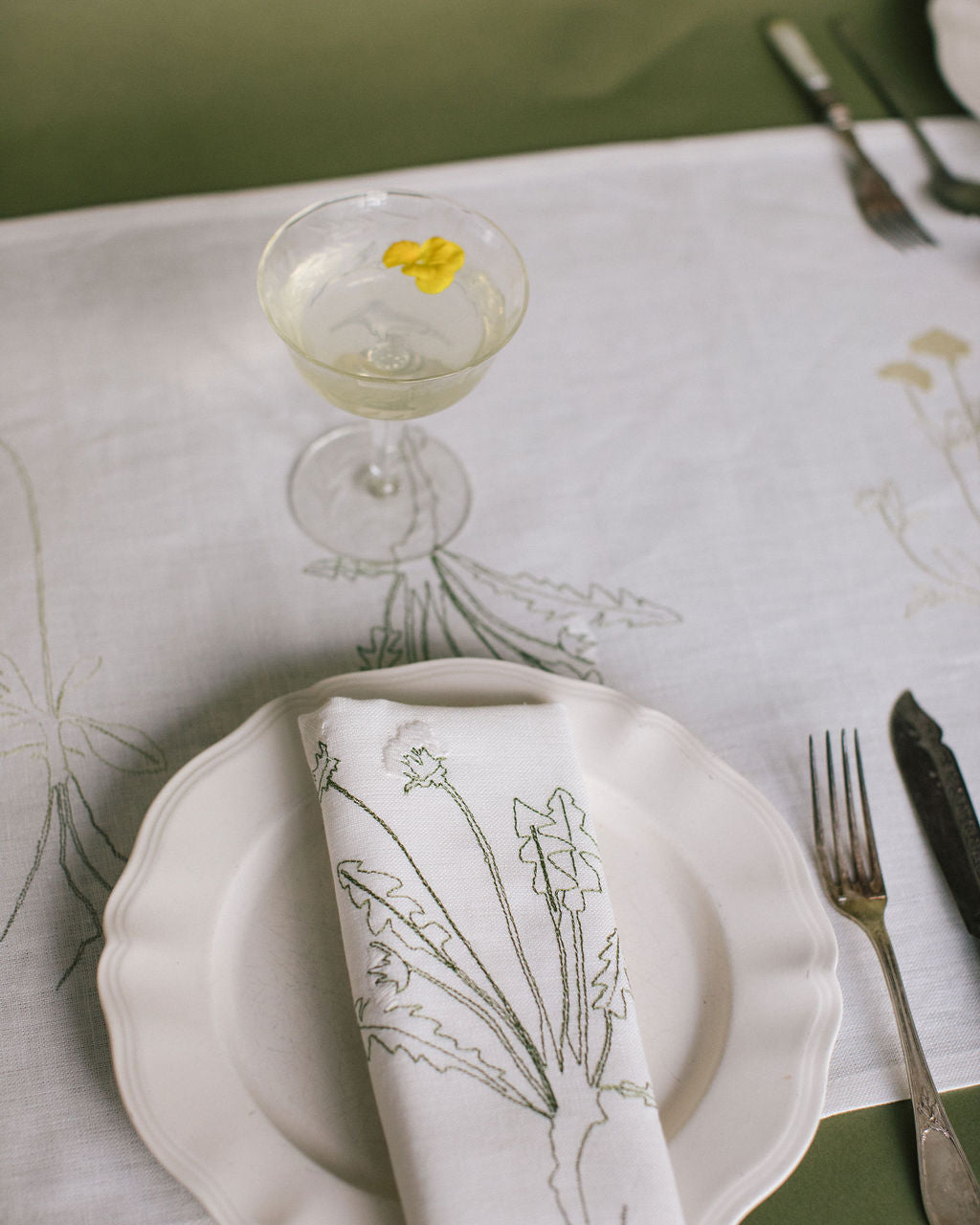 Irish linen napkin with coloured embroidery of a plant