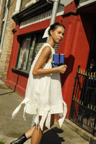 Irish linen A line dress, with appliqué bows and a deep hem finishing just above the knee. 