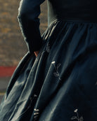 long sleeve irish linen dress in navy with a fitted bodice and ivory wildflower embroidery on skirt 