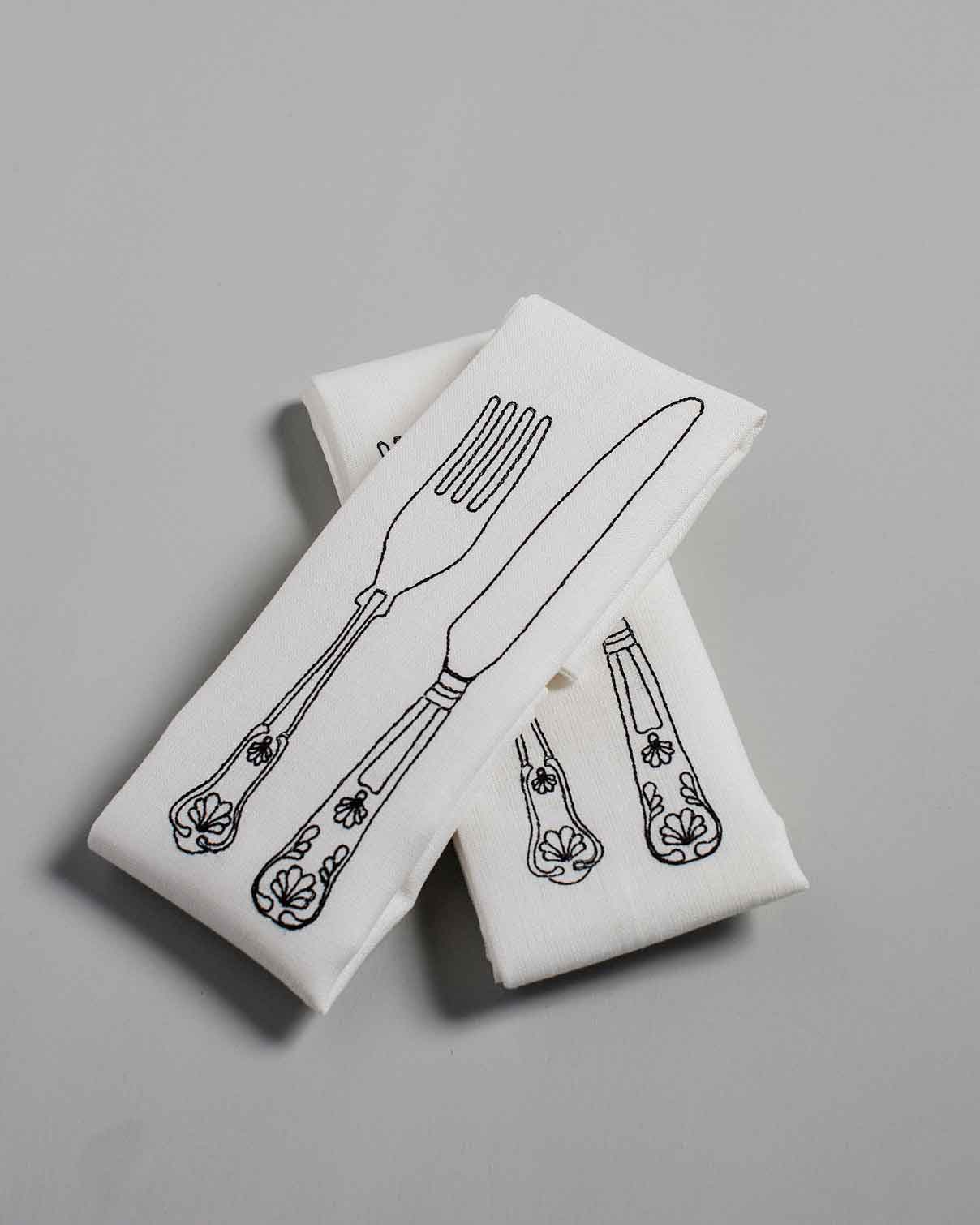 White Irish linen napkin with black knife and fork embroidery 