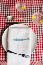 Irish linen napkin with embroidery of a fork , lemon and a fish on a plate 