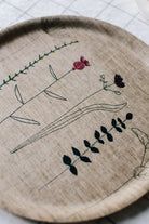 Round Irish linen tray with wildflower embroidery 
