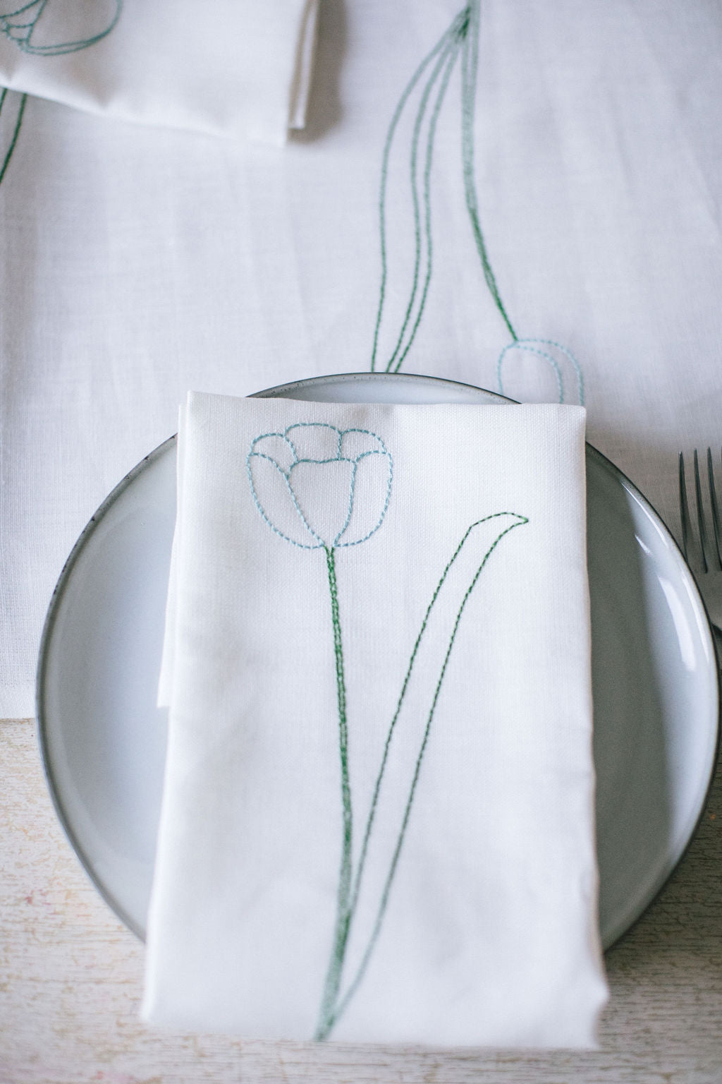 White irish linen napkin with embroidery of tulip line drawings 