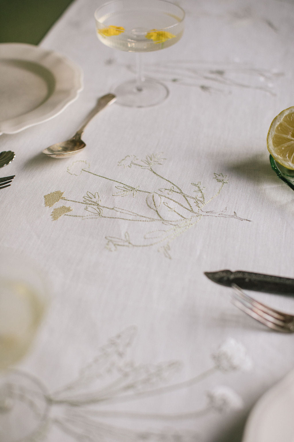 Plant embroidery on a white Irish linen table runner 