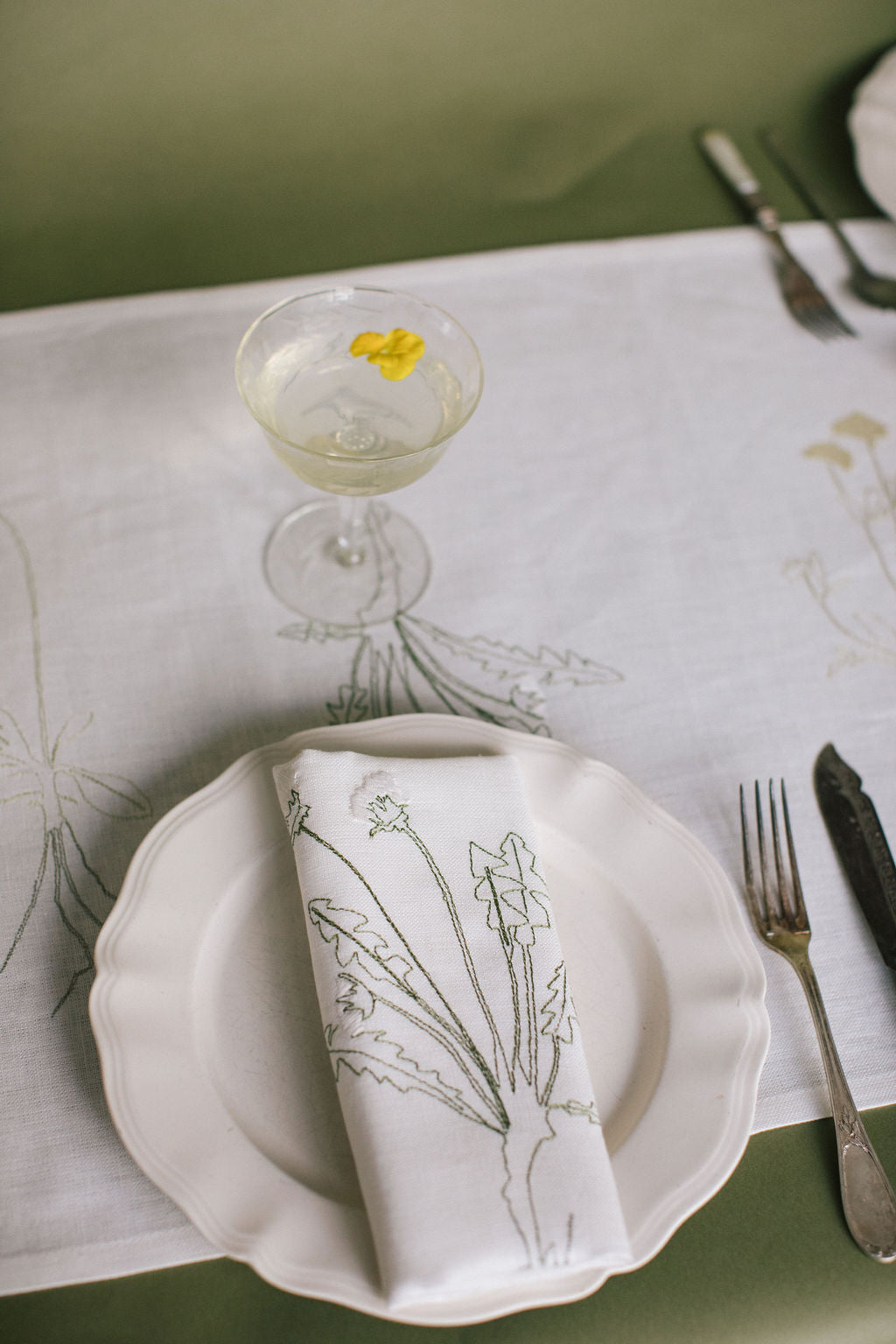 Irish linen napkin with coloured embroidery of a plant 