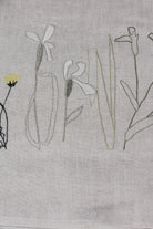 Irish linen tablerunner with plant embroidery in earthy green colours 