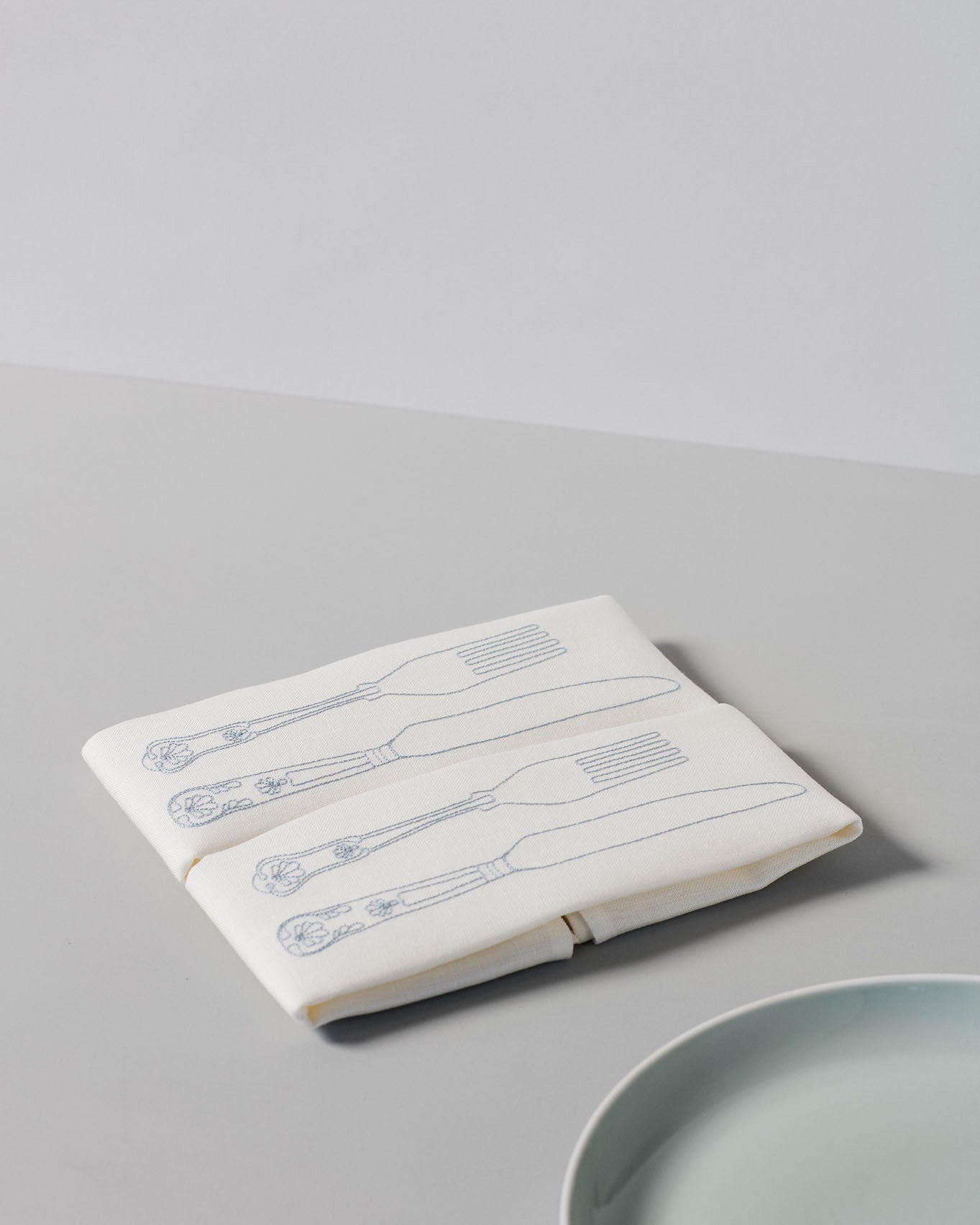 Irish linen napkin with powder blue knife and fork embroidery 