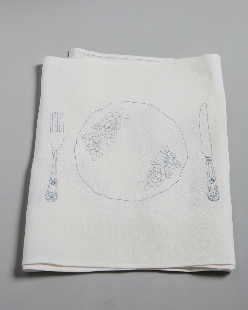 Powder blue embroidery of a knife, fork and plate on an Irish linen table runner 
