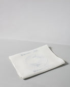Irish linen tablerunner with powder blue embroidery of a table setting 