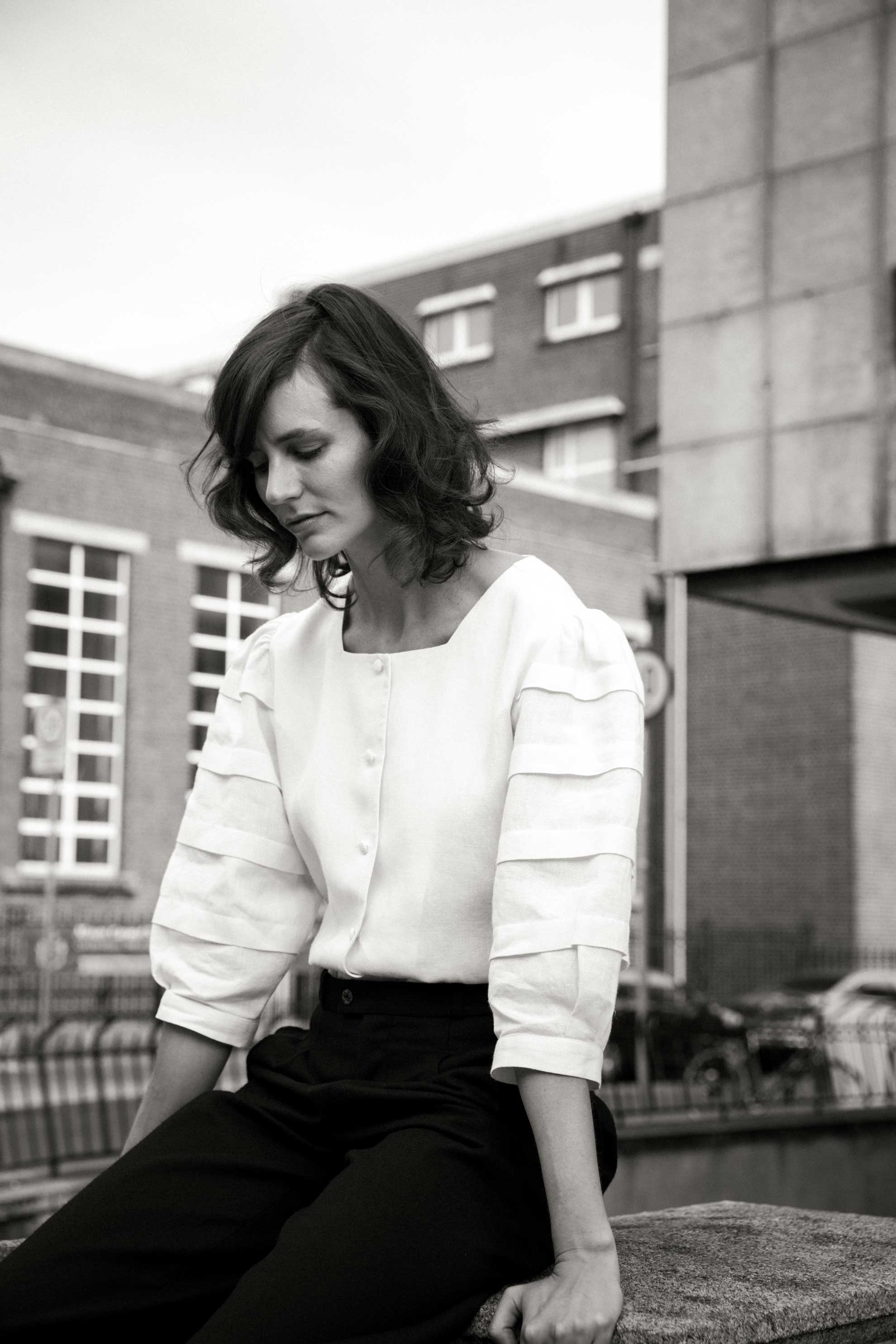 ivory irish linen top with a square neckline, cover buttons on the centre front and pleated sleeve details 
