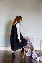 Pinafore dress in midi length with buttons running down the centre 