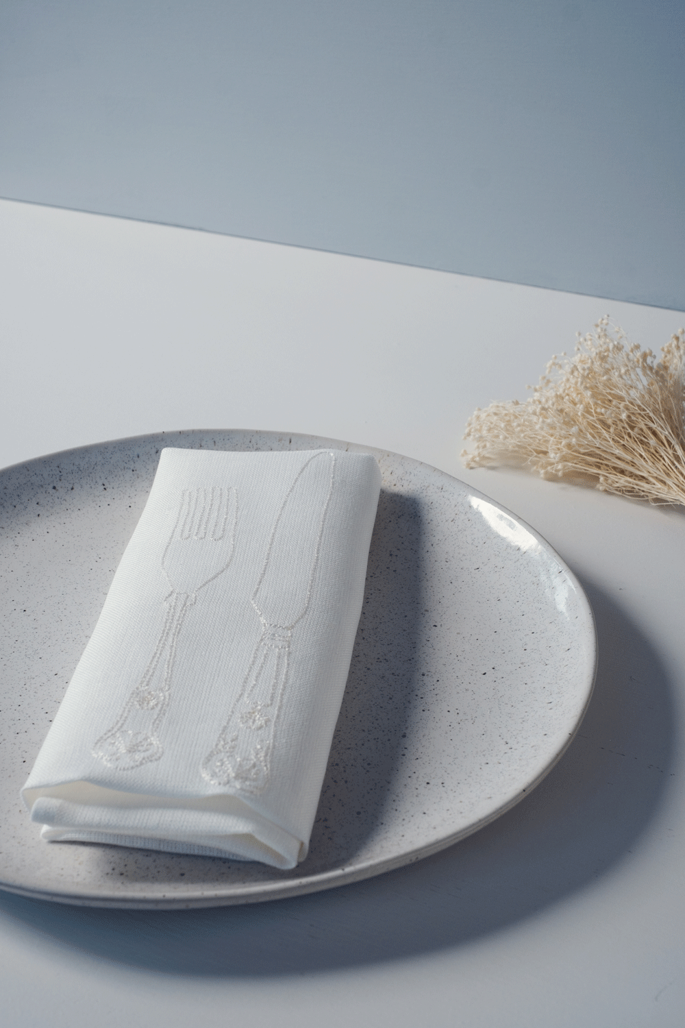 White Irish linen napkin with tonal knife and fork embroidery 