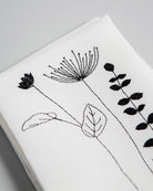 Irish linen napkin with embroidery of three Irish wildflowers